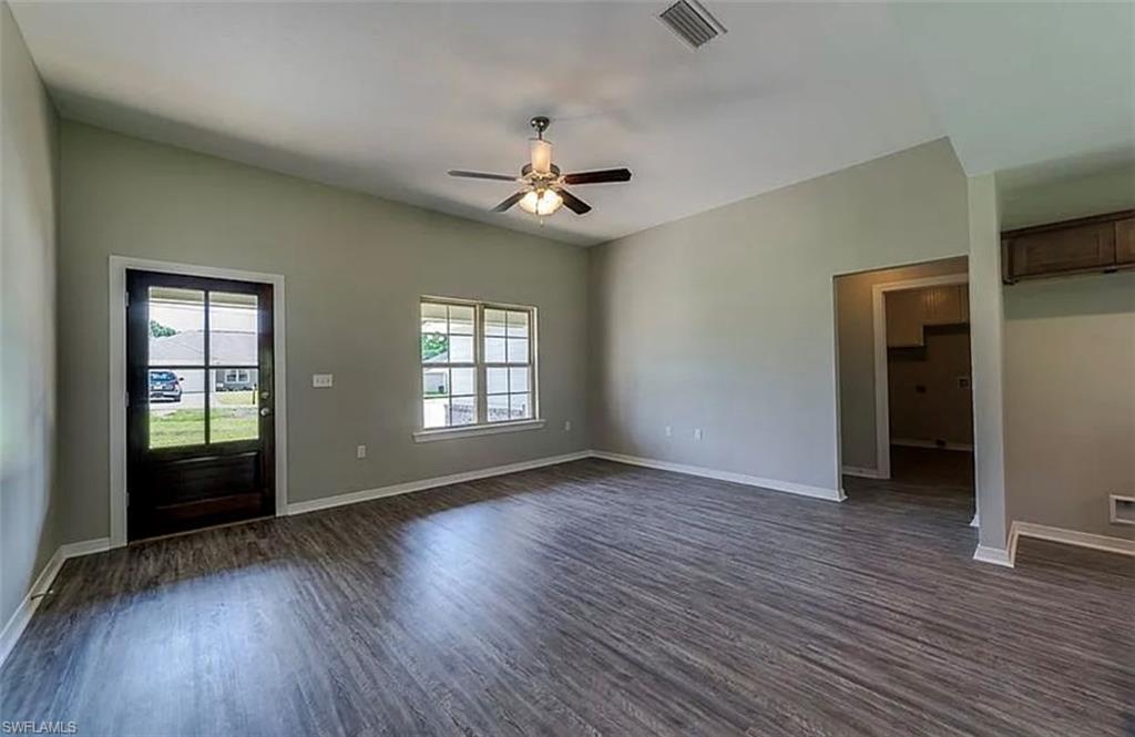 Entrance foyer featuring dark wood-type flooring and a ceiling fan