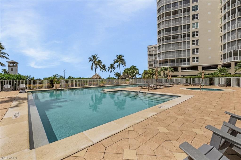 Community pool with a patio and a community hot tub