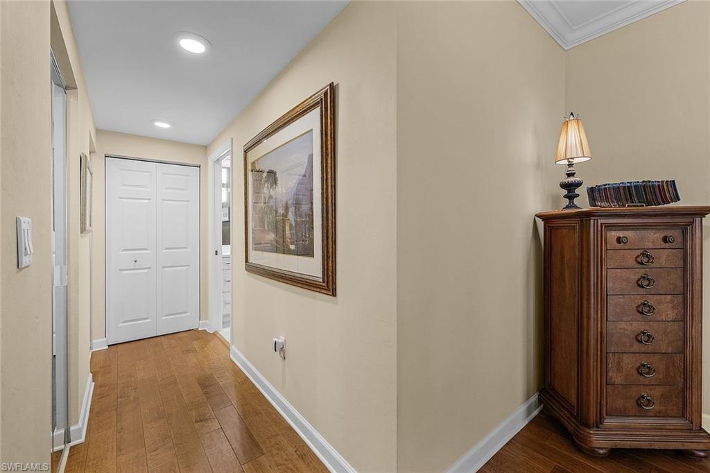 Hallway featuring dark wood-style flooring and recessed lighting