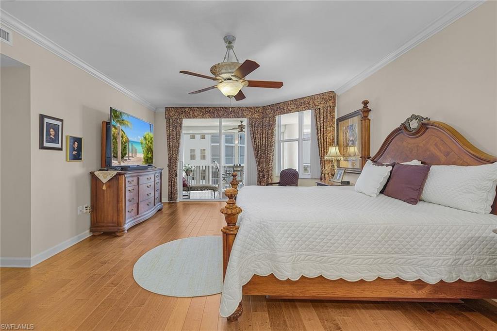 Bedroom with crown molding, light wood finished floors, access to outside, and a ceiling fan