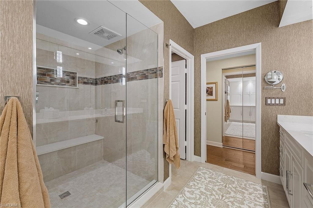 Full bath featuring a stall shower, vanity, light tile patterned floors, recessed lighting, and a closet