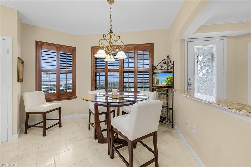 Dining space with a chandelier and baseboards