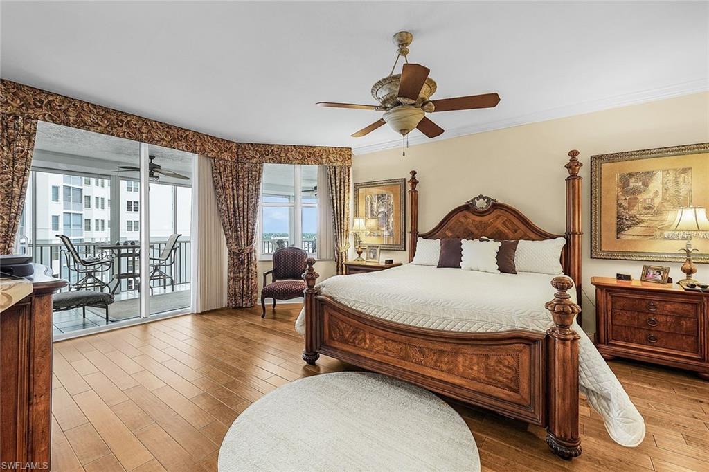 Bedroom featuring wood finished floors, ornamental molding, access to exterior, and a ceiling fan