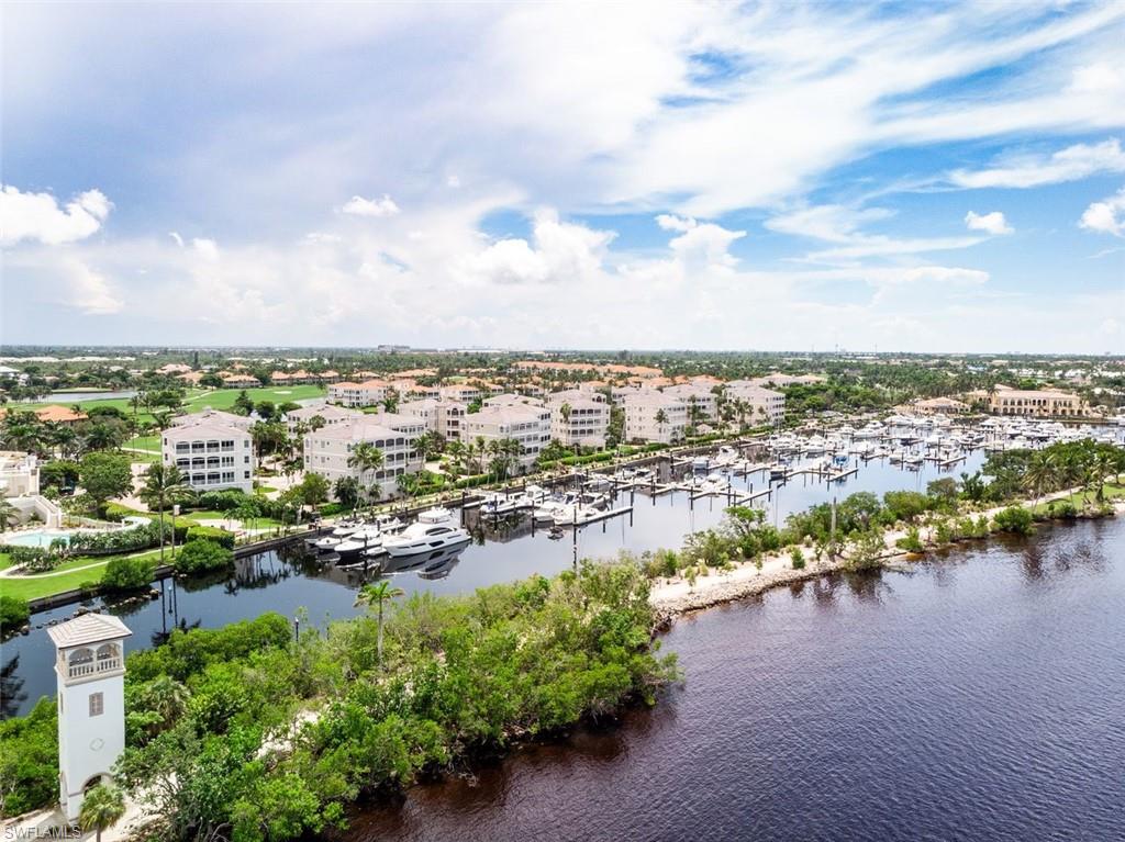 Drone / aerial view of numerous boat docks and a nearby body of water
