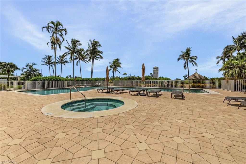 Community pool with a hot tub and a patio area