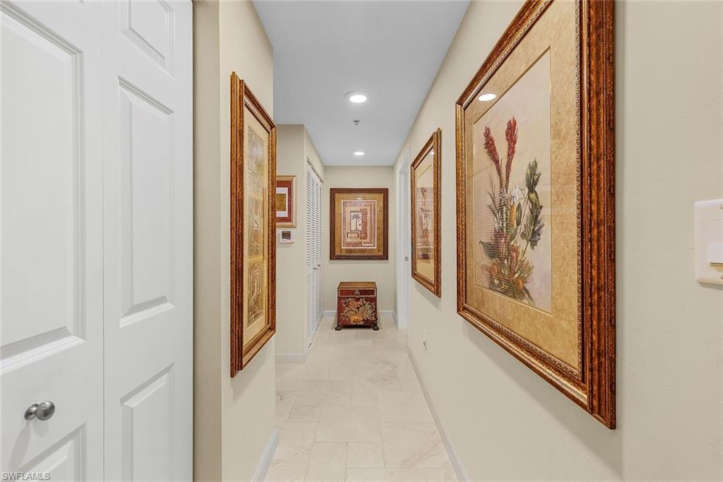 Hall with baseboards and recessed lighting