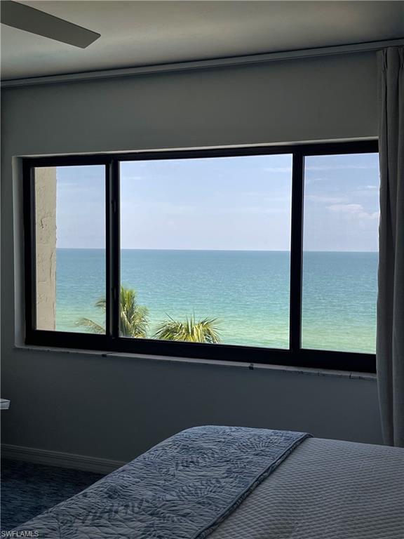 Bedroom with a water view and baseboards
