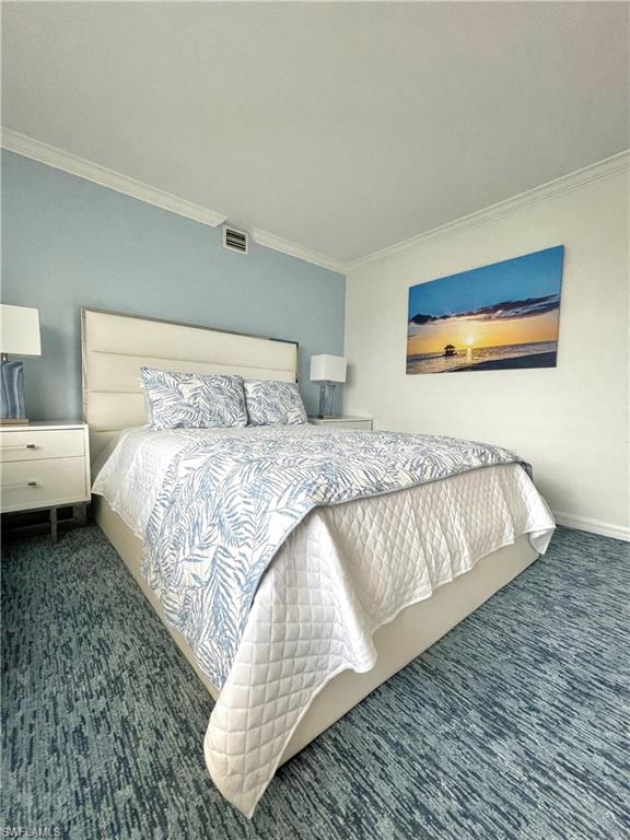 Bedroom featuring ornamental molding and carpet