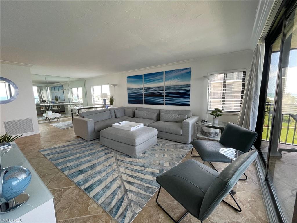 Tiled living area featuring ornamental molding