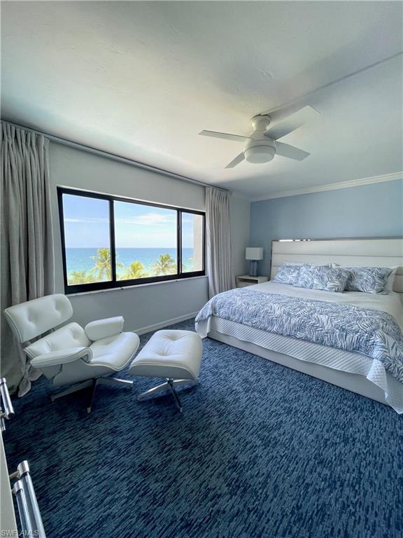 Bedroom featuring a water view, a ceiling fan, and carpet