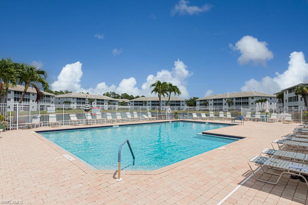 Community pool featuring a patio area and a residential view