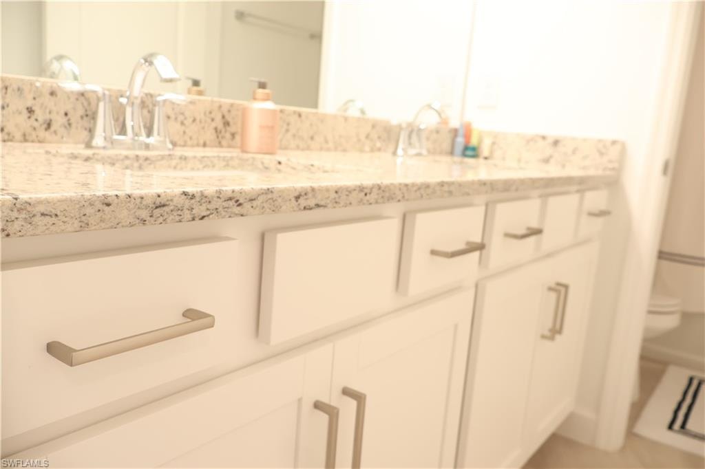 Bathroom with double vanity and toilet