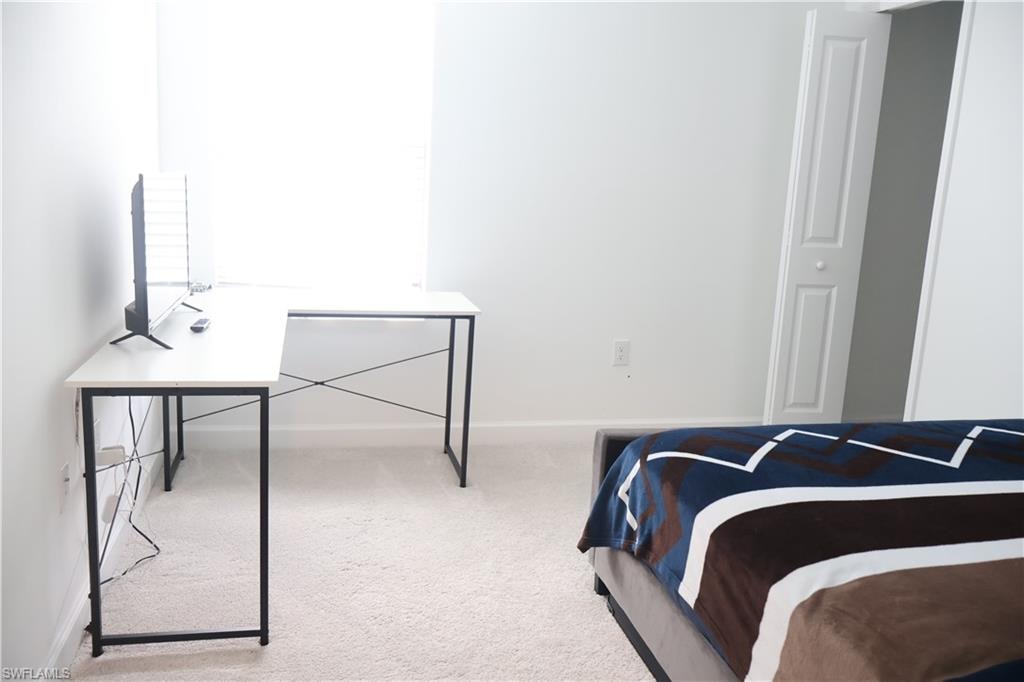 Carpeted bedroom with baseboards