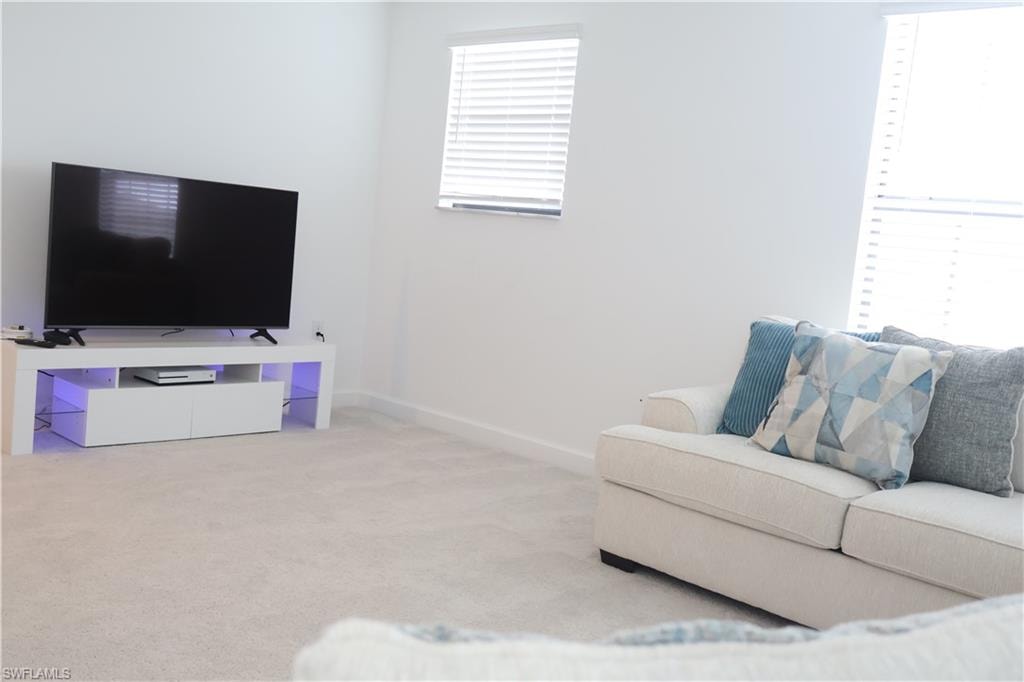 Living room with carpet flooring and baseboards
