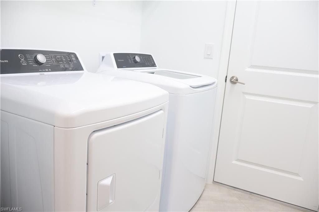 Laundry room featuring washing machine and clothes dryer