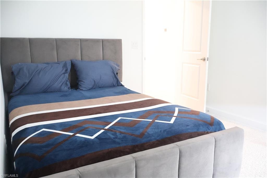 Bedroom with carpet flooring and baseboards