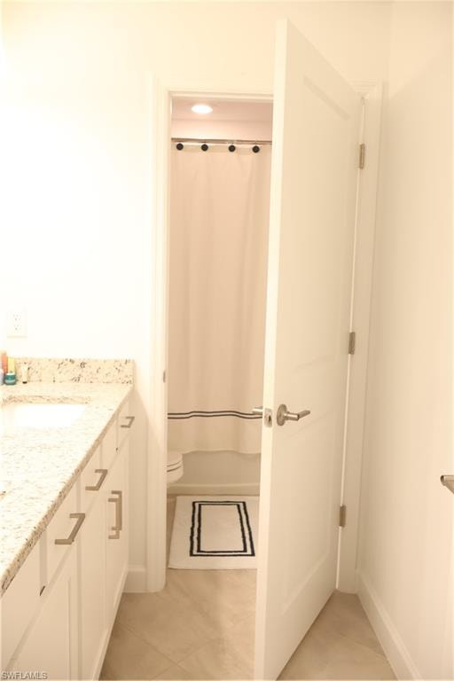 Bathroom with vanity, light tile patterned flooring, and shower / bath combo