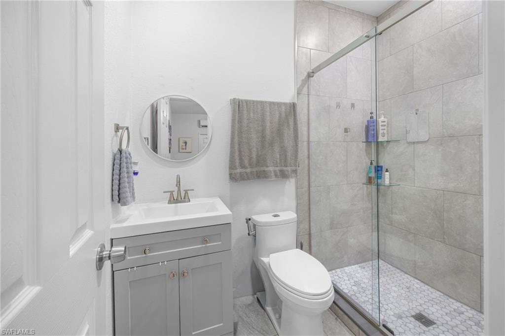 Bathroom with a shower stall and vanity