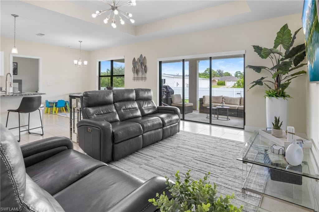 Rear view of property with a fenced backyard, a patio, and stucco siding