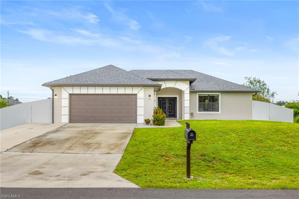 View of front of home featuring roof with shingles, concrete driveway, stucco siding.