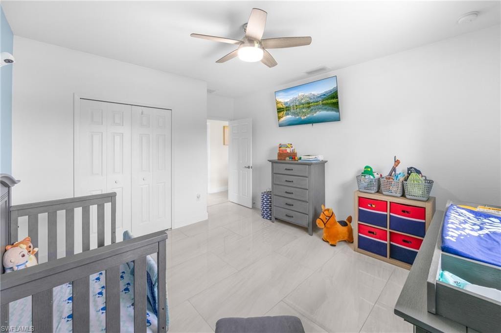Tiled bedroom featuring a closet and ceiling fan