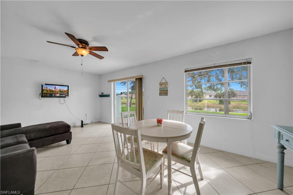 Dining space with light tile patterned floors and ceiling fan