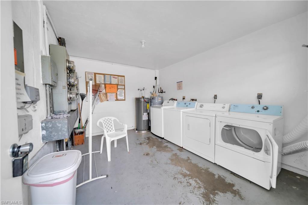 Laundry area featuring water heater and washer and clothes dryer