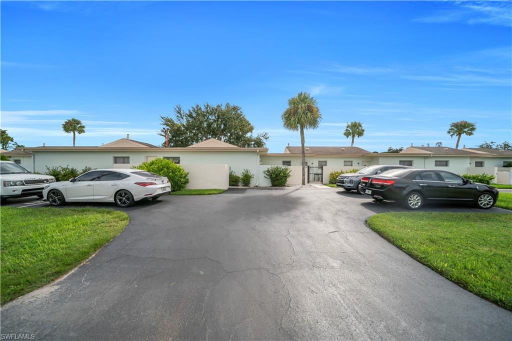 Single story home with a front lawn and uncovered parking