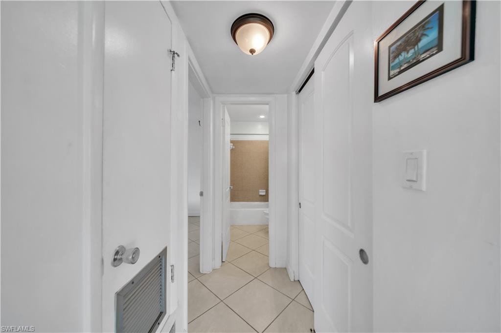 Hallway featuring light tile patterned floors and a barn door