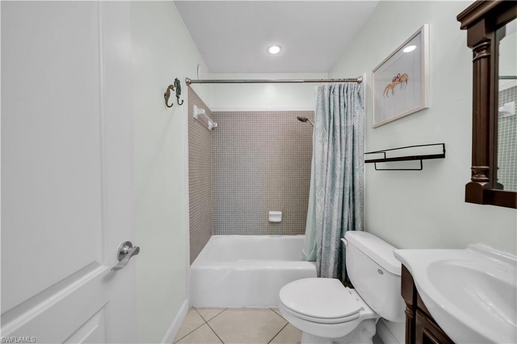 Bathroom with shower / bath combo, vanity, light tile patterned floors, and recessed lighting