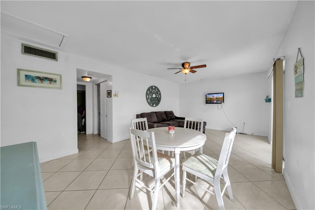 Dining area featuring light tile patterned floors and ceiling fan