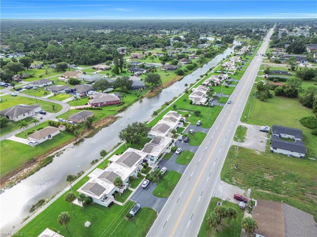 Aerial view of property's location featuring nearby suburban area and a nearby body of water