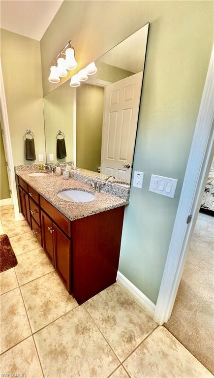 Bathroom featuring double vanity and light tile patterned floors