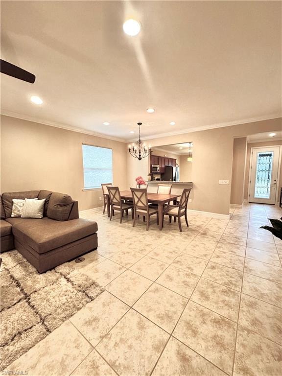 Dining space featuring healthy amount of natural light, recessed lighting, crown molding, light tile patterned floors, and a chandelier