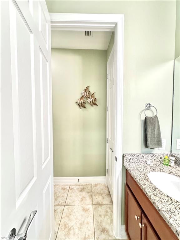 Bathroom with vanity and light tile patterned floors