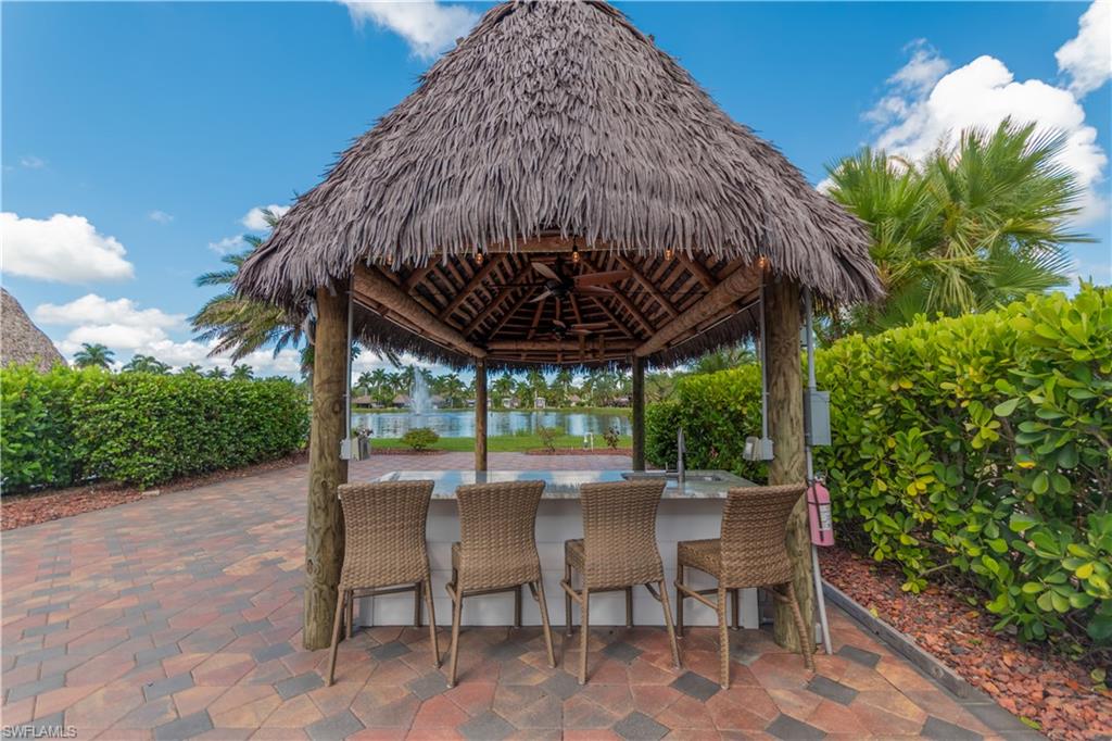 View of patio / terrace with a gazebo and a water view