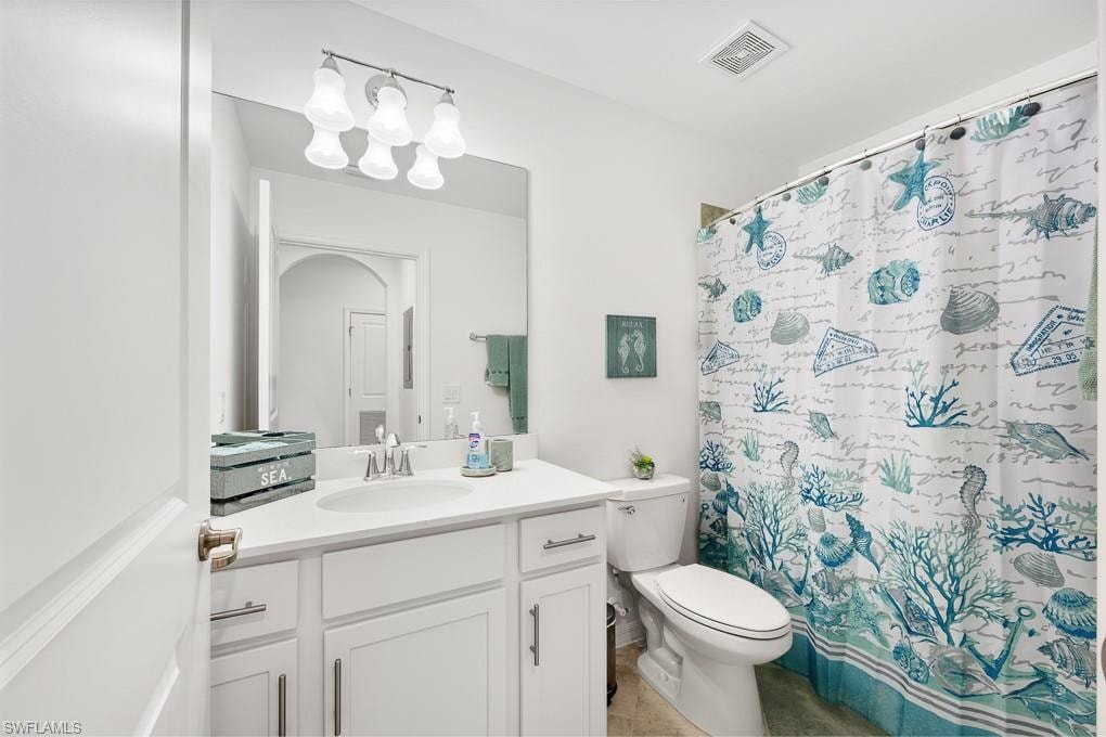 Bathroom featuring vanity, a shower with curtain, and light tile patterned flooring