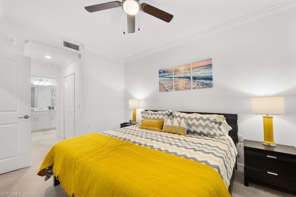 Bedroom with light carpet, crown molding, a closet, and ceiling fan