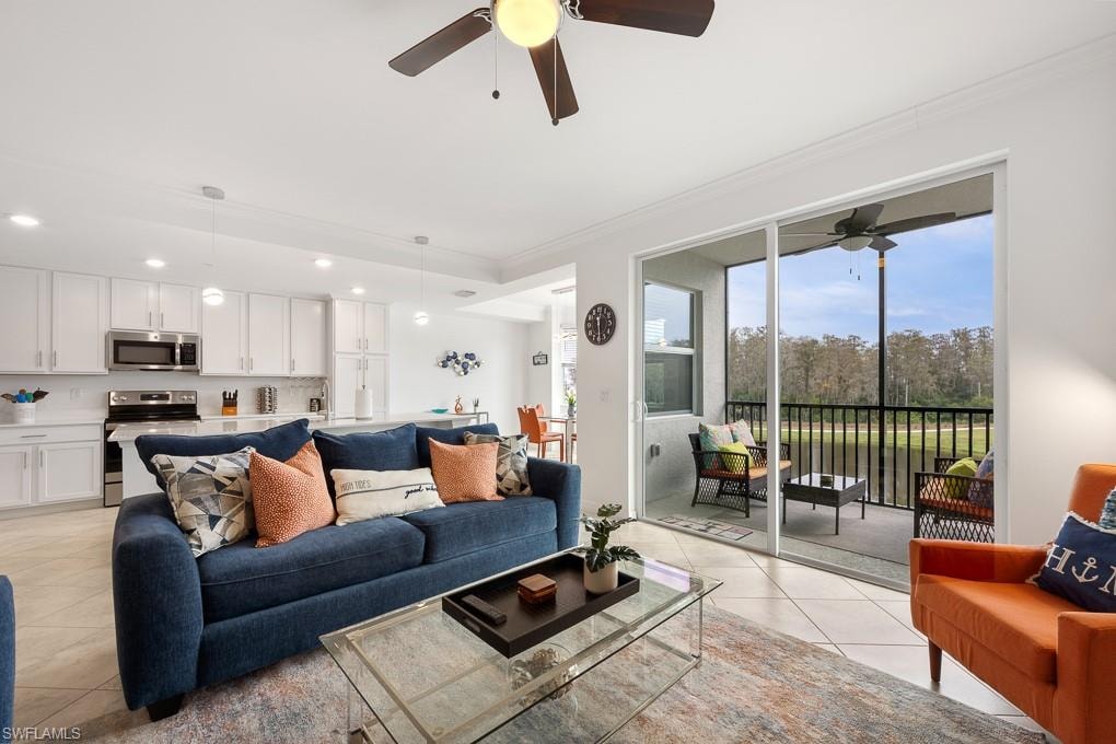 Living room with light tile patterned floors, recessed lighting, a ceiling fan, and ornamental molding
