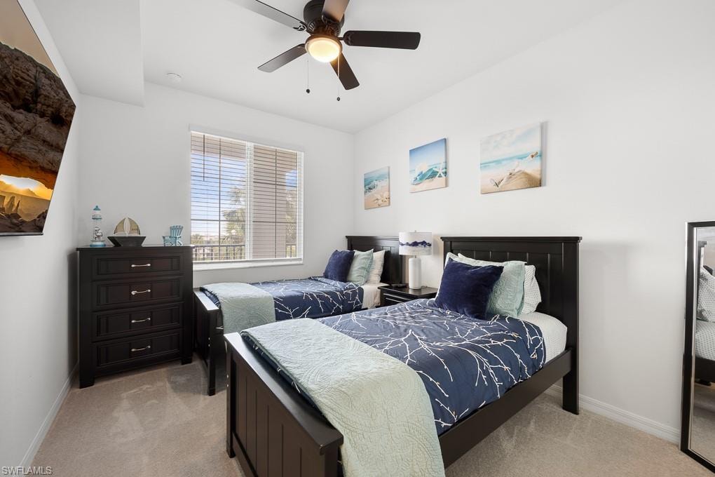 Bedroom featuring light colored carpet and ceiling fan