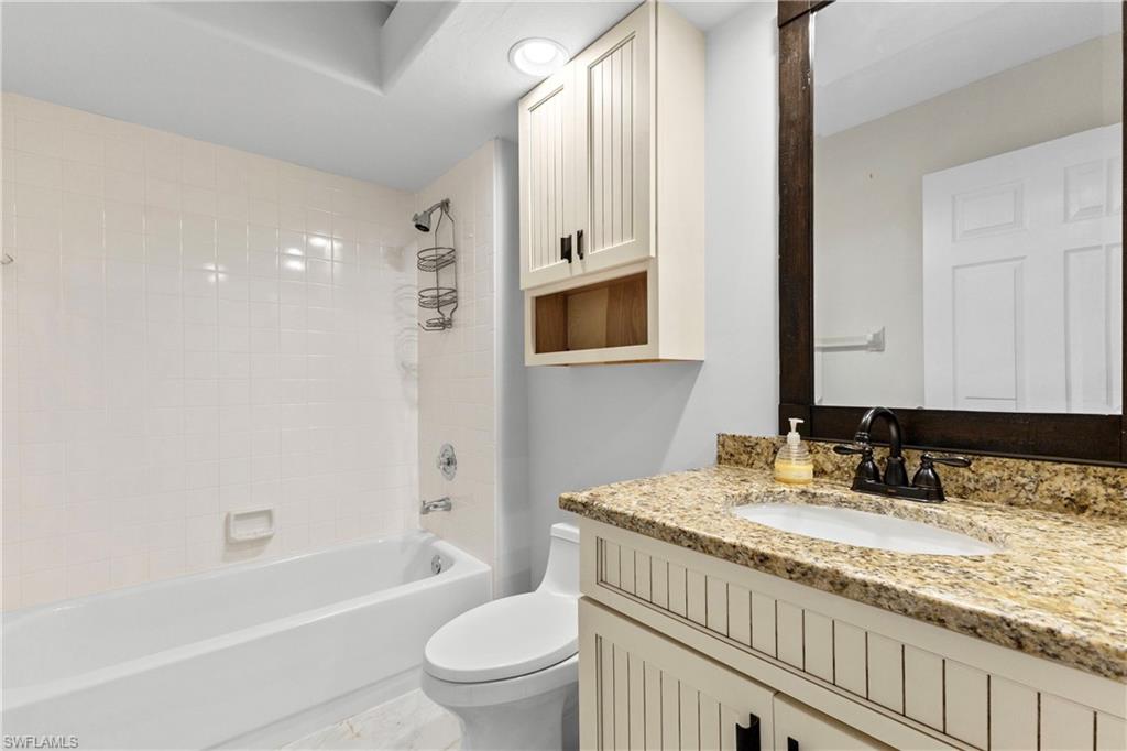 Bathroom with shower / bath combination and vanity
