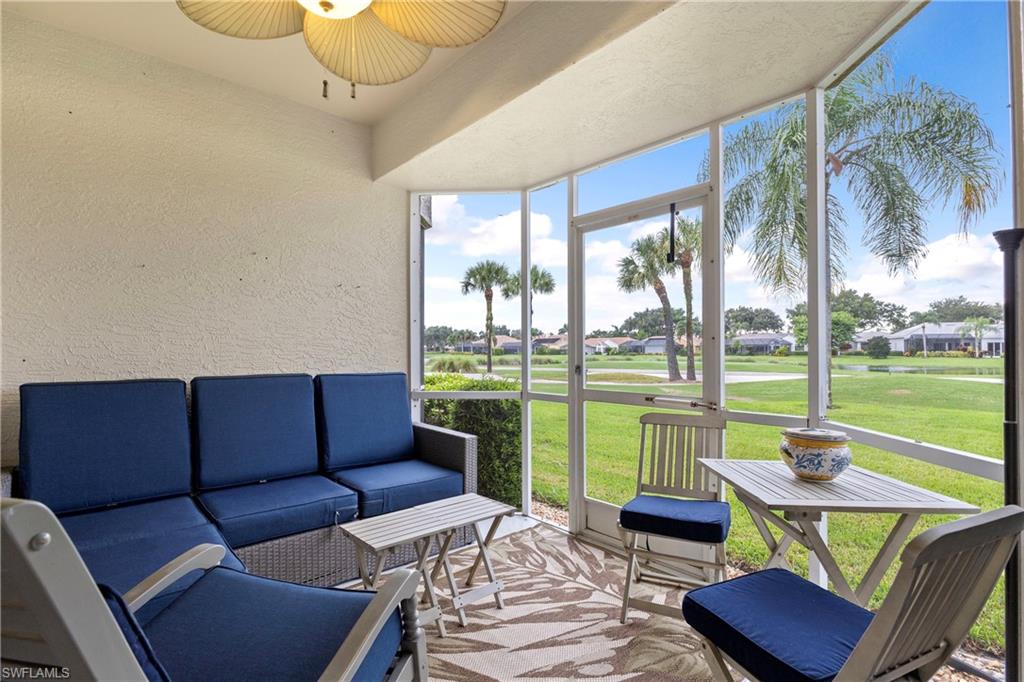 Sunroom with outdoor lounge area, a ceiling fan, and view of golf course