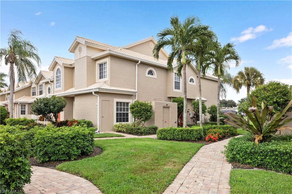Mediterranean / spanish house featuring a front lawn, stucco siding, and a tiled roof