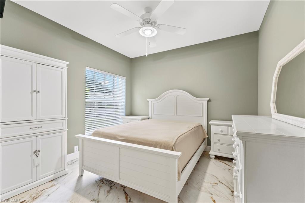 Bedroom with light marble finish flooring and ceiling fan