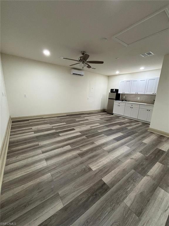 Unfurnished living room featuring wood finished floors, ceiling fan, and recessed lighting