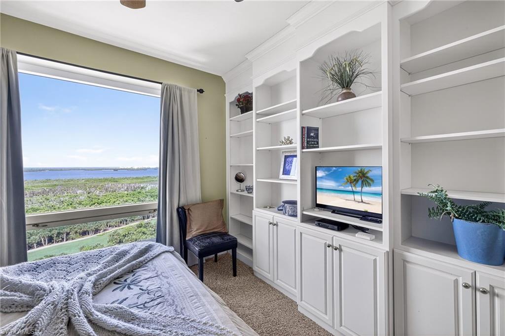 Bedroom with light colored carpet and ceiling fan