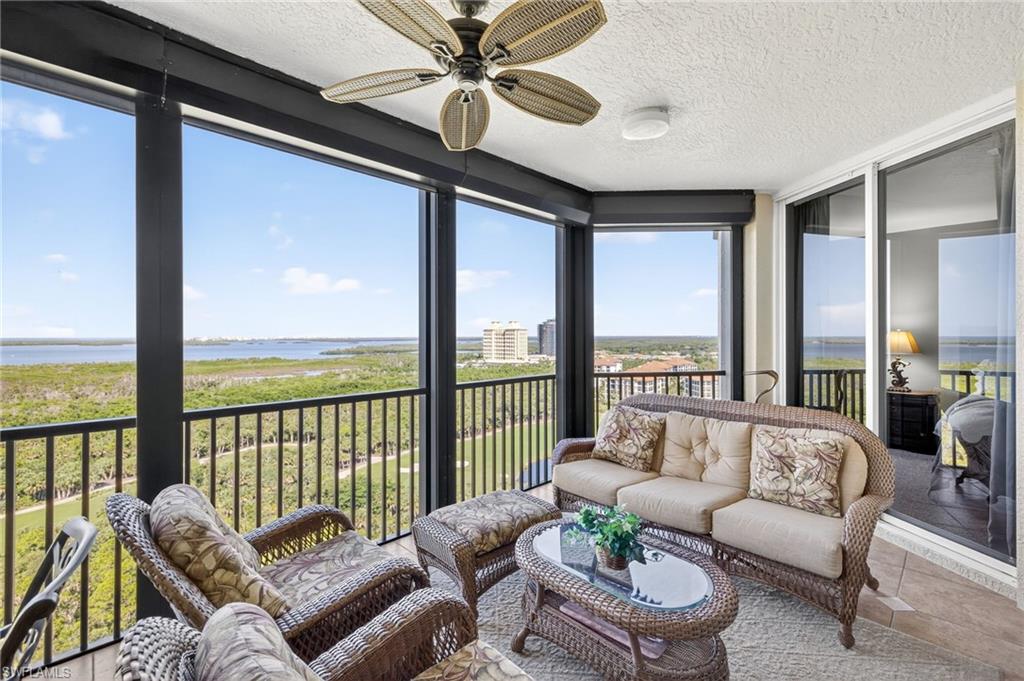 Featuring a water view, a balcony, an outdoor hangout area, a ceiling fan, and tile patterned floors