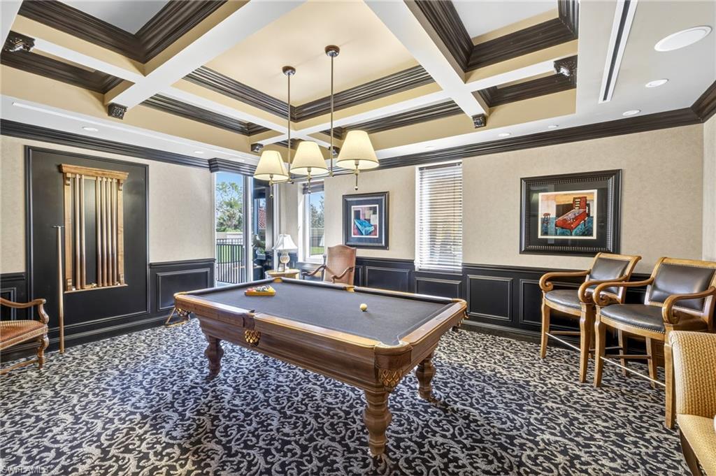 Recreation room with a decorative wall, ornamental molding, pool table, wainscoting, and carpet floors