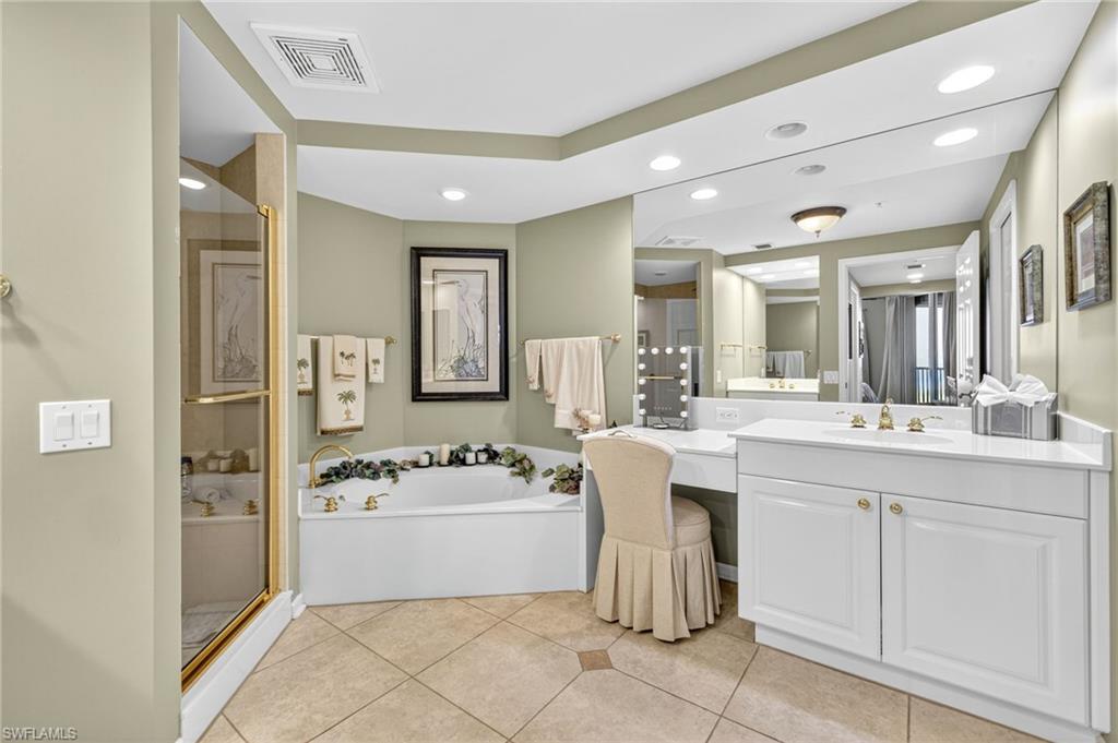 Full bath with a garden tub, a shower stall, vanity, light tile patterned flooring, and recessed lighting