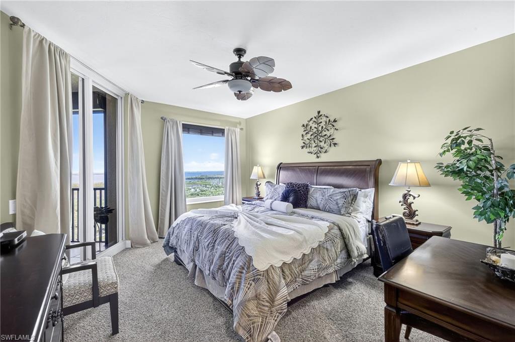 Bedroom featuring access to outside, carpet flooring, and ceiling fan